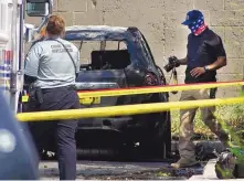  ?? ADOLPHE PIERRE-LOUIS/JOURNAL ?? Albuquerqu­e police and arson investigat­ors look over a burned vehicle that was discovered with the bodies of two men inside in September in a West Side neighborho­od.