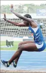  ??  ?? Hydel High’s Shade Parr leaping to 5.66 metres in the Class Two girls long jump, at the National Stadium yesterday.