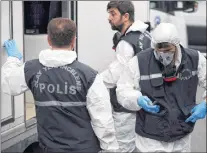  ?? AP PHOTO ?? Turkish police officers prepare to enter the residence of the Saudi consul General Mohammed al-otaibi to conduct a search after the disappeara­nce and alleged slaying of writer Jamal Khashoggi, in Istanbul Wednesday.