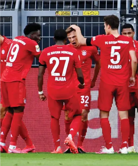  ?? Reuters ?? Bayern Munich players celebrate Joshua Kimmich’s strike just before half time, a sublime chip past the goalkeeper