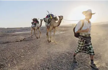  ?? JOHN STANMEYER/NATIONAL GEOGRAPHIC SOCIETY/THE ASSOCIATED PRESS ?? In this Jan. 28 photo, journalist Paul Salopek walks across the Afar desert of Ethiopia as part of his planned seven-year global trek from Africa to Tierra del Fuego, Chile. The reporter now has only 32,000 kilometres to go.