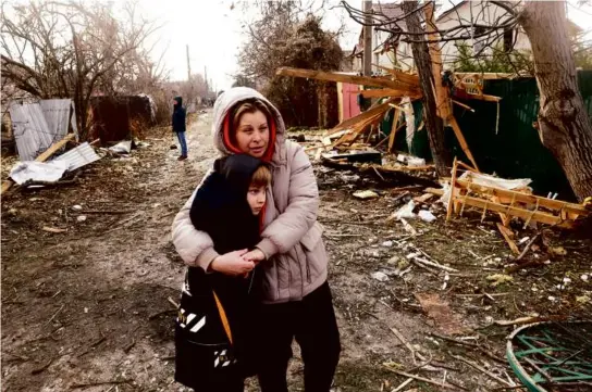  ?? ANATOLII STEPANOV/AFP VIA GETTY IMAGES ?? Residents stood among debris after a drone attack in Tairove, in Ukraine’s Odesa region, on Sunday.