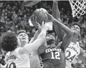  ?? Charlie Riedel Associated Press ?? KENTUCKY’S Keion Brooks is pressured by Kansas’ Jalen Wilson, Christian Braun and K.J. Adams.