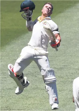  ?? Picture: AFP ?? MILESTONE. Australian batsman David Warner leaps high in elation as he celebrates his century on the opening day of the fourth Ashes Test in Melbourne yesterday.