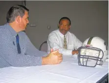  ?? STAFF PHOTO BY RON BUSH ?? Tim Freeman, right, owner and general manager of the Peach State Cats, chats with the Dalton Convention Center’s Grant Shell about plans for the indoor football team’s 2018 season.