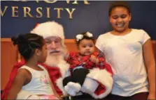 ?? SUbMitted PhOtOs — KaRen sMith/nORth liGht COMMUnitY CenteR ?? Children from Manayunk’s north light Community Center enjoy a visit with santa at a Christmas party sponsored by Villanova University dec. 9 on campus.