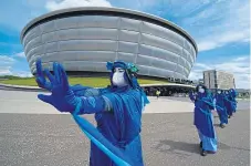  ?? ?? Extinction Rebellion Scotland’s Blue Rebels perform outside the Glasgow venue for COP26.