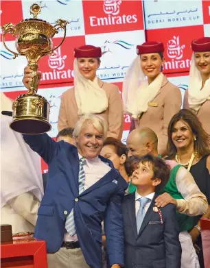  ?? Getty Images ?? Trainer Bob Baffert celebrates with the trophy after jockey Mike Smith powered Arrogate to Dubai World Cup triumph. —