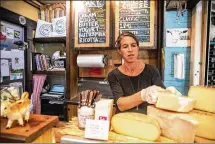  ?? NYT ?? Anne Saxelby of Saxelby Cheese Mongers, organizes cheese at her shop in Manhattan. Like the price of oil, silver and hogs, cheese prices are set, in part, by traders in commoditie­s markets.