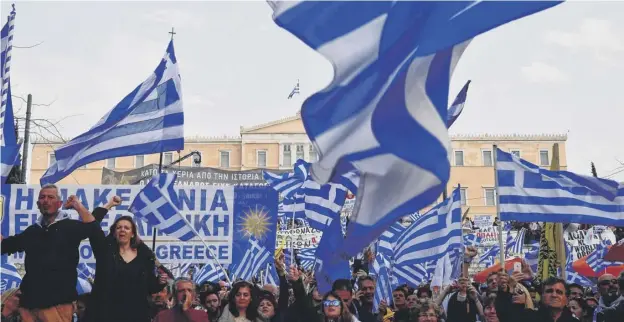  ?? PICTURE: LOUISA GOULIAMAKI/GETTY IMAGES ?? 0 Protesters wave Greek flags as they urge the government not to compromise in the name row with neighbouri­ng Macedonia