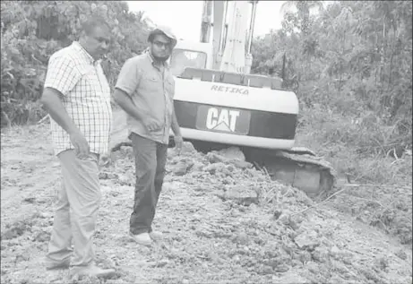  ??  ?? Vice Chairman of Region Six, Denis Deroop (at left) checking on works being carried out on the Molson Creek road