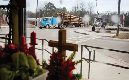  ?? David Goldman photos / Associated Press ?? A logging truck passes through Lula, Ga. “This is Trump country up here,” explains resident Margaret Luther.