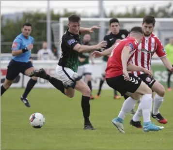  ??  ?? Bray’s Anthony Flood back heels the ball to keep possession during the clash with Derry City.