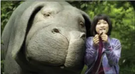  ??  ?? This image released by Netflix shows Seo-Hyun Ahn as Mija and the character Okja in a scene from “Okja.”