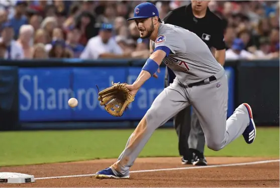  ?? | GETTY IMAGES ?? Cubs third baseman Kris Bryant fields a bouncer to begin a double play in the first inning Saturday against the Diamondbac­ks. Bryant went 3- for- 4 with two RBI.