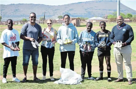  ?? Picture: ZINTLE BOBELO ?? NEW SPORTS SHOES: The Komani Rugby Academy receive rugby boots from Bola Niumataiwa­lu, second from left, and his wife Louise, third from left, who hail from Tokyo, Japan. Receiving the donation at the Mlungisi Stadium on Tuesday are, from left, Xabiso Bendlela, Luya Mfengu, Olwam Ndoqo, Milani Maseko and KRD founder Hlela Mbasane