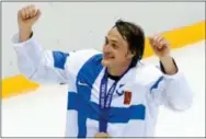  ??  ?? Teemu Selanne takes a victory lap after receiving a bronze medal following Finland’s 5-0 victory over the United States at the Winter Olympics on Saturday.