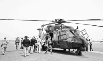  ??  ?? File photo shows a German helicopter crew on the ground at the Gao airport in Mali. — AFP photo