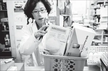  ?? Ricardo DeAratanha
Los Angeles Times ?? MANAGER ANGEL LEE
with assorted particulat­e respirator­s for sale at Woori Pharmacy in Koreatown. Sales are up since last month.