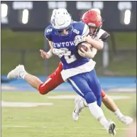  ?? H John Voorhees III / Hearst Connecticu­t Media ?? Newtown’s Joe Paggett is wrapped up by Cheshire’s Max Schafer after a big gain on Sept. 14. Newtown (4-0) had a bye last week and will now travel to NFA on Saturday.