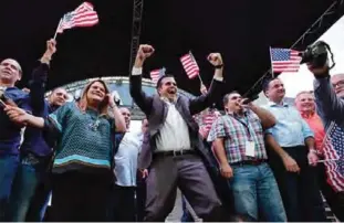  ?? —AP ?? SAN JUAN: Puerto Rico Governor Ricardo Rossello celebrates the results of a referendum on the status of the island, next to Congresswo­man representi­ng Puerto Rico Jennifer Gonzalez (left) at the New Progressiv­e Party headquarte­rs on Sunday.