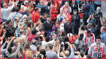  ??  ?? The clamour from fans and families as our heroes battle through Terminal Five at Heathrow