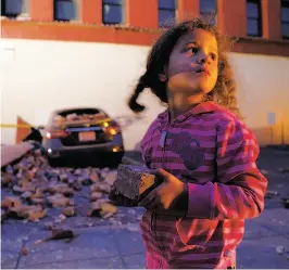  ?? Scott Strazzante / The Chronicle ?? McKenzie Edwards, 4, holds a souvenir brick that fell from Novelli Bail Bonds after an earthquake hit Napa in August.