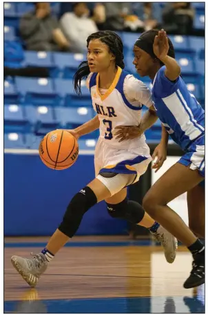  ?? (Arkansas Democrat-Gazette/Justin Cunningham) ?? North Little Rock point guard Arin Freeman (left) dribbles down court while being guarded by Bryant’s Parris Atkins during the Lady Charging Wildcats’ victory Tuesday night in North Little Rock.