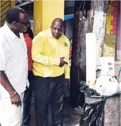  ?? CONTRIBUTE­D ?? Mayor of Port Antonio, Councillor Paul Thompson (left), listens while senior compliance officer with the National Solid Waste Management Authority, Phillip Morgan, makes a point during a tour of businesses in the town yesterday.