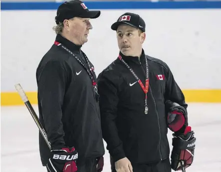  ?? THE CANADIAN PRESS ?? Luke Pierce, right, joins the Oil Kings after a stint with the Canadian sledge hockey team that won silver in Pyeongchan­g. Pierce is shown here chatting with Canadian head coach Ken Babey.