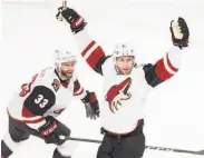  ?? Ryan Remiorz / Associated Press ?? Coyotes left wing Taylor Hall (right) celebrates with Alex Goligoski after scoring against Montreal.