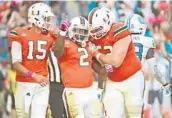  ?? JIM RASSOL/STAFF FILE PHOTO ?? Miami Hurricanes running back Joseph Yearby, center, celebrates a touchdown in with quarterbac­k Brad Kaaya, at left, and offensive lineman Kc McDermott.