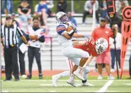  ?? Matthew Brown / Hearst Connecticu­t Media ?? Danbury’s Brenyn Boswell makes a reception at midfield against Greenwich’s Evan Weigold on Saturday at Cardinal Stadium in Greenwich.