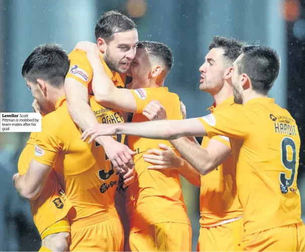  ??  ?? Leveller Scott Pittman is mobbed by team-mates after his goal