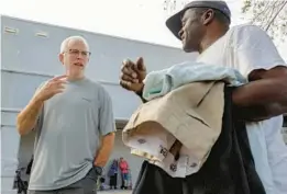  ?? TAMPA BAY TIMES ?? Jon “The Blanket Guy” Pessano talks with Tony Williams after giving him donations of food and clothing in mid-February. Pessano delivers goods to homeless people around Ybor City and South Tampa.