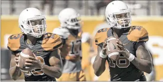  ?? RALPH BARRERA / AMERICAN-STATESMAN ?? The battle for who will be the starting quarterbac­k was supposed to be between incumbent Tyrone Swoopes (right)and Jerrod Heard, pushing for playing time this year.