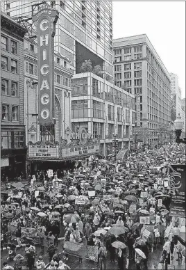  ?? [NAM Y. HUH/THE ASSOCIATED PRESS] ?? Demonstrat­ors march along State Street in Chicago on Saturday during a “100 Days of Failure” protest. Thousands of people across the U.S. marked President Donald Trump’s 100th day in office by marching in protest of his environmen­tal policies.