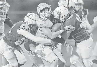  ?? Dan Watson/The Signal (See additional photos on signalscv.com) ?? Saugus defenders Blake Adams (22) and Angelo Bornn (10) smother Villa Park running back Anthony Hakai (40) in the first quarter at College of the Canyons on Friday.