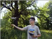  ?? NATACHA PISARENKO — THE ASSOCIATED PRESS ?? Andriy Pokrasa, 15, lands his drone on his hand during an interview with The Associated Press in Kyiv, Ukraine, Saturday, June 11. Andriy is being hailed in Ukraine for stealthy aerial reconnaiss­ance work he has done with his dad in the ongoing war with Russia. They used their drone to help the country’s military spot, locate and destroy