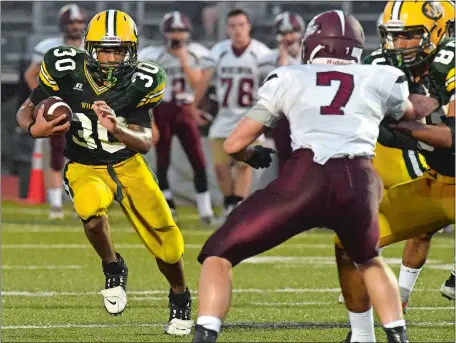  ?? DANA JENSEN/THE DAY ?? New London’s Jacob Commander, left, looks for running room during the Whalers’ season-opening 31-0 victory over East Lyme on Friday in an Eastern Connecticu­t Conference Large Division game.