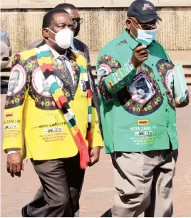  ??  ?? President Mnangagwa (left), accompanie­d by Secretary for Administra­tion Cde Obert Mpofu, arrives for the ZANU PF Politburo meeting at the party headquarte­rs in Harare yesterday