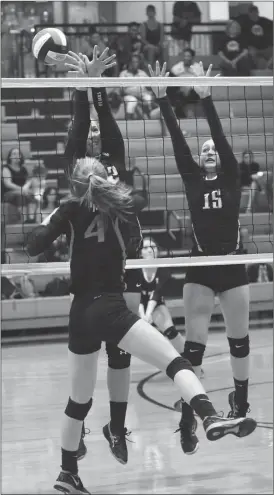  ??  ?? LaFayette's Katie Dixon puts a shot past the block attempts of Tori Elliott (left) and Zady Carden. (Messenger photo/Scott Herpst)