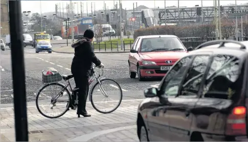  ??  ?? A cyclist navigates Ashford’s shared space system