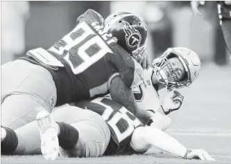  ?? AUSTIN ANTHONY
THE ASSOCIATED PRESS ?? New England Patriots quarterbac­k Tom Brady is sacked by Tennessee Titans defensive end Jurrell Casey (99) and linebacker Harold Landry on Sunday in Nashville. Brady was sacked three times in the game.