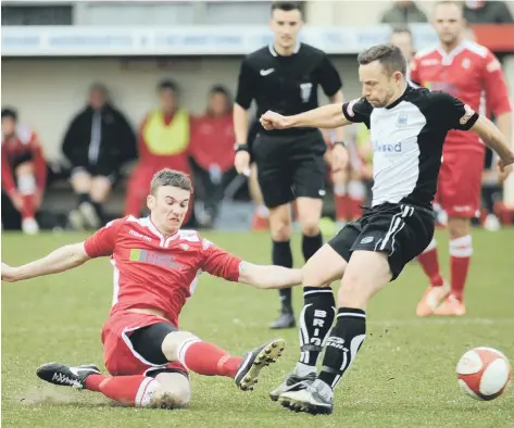  ??  ?? Sub Kieran McCaffrey goes in hard on Bamber Bridge’s former Hull City midfielder Paul McKenna