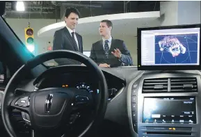  ?? SEAN KILPATRICK / THE CANADIAN PRESS FILES ?? Blackberry QNX director of engineerin­g Sheridan Ethier speaks to Prime Minister Justin Trudeau on a tour of a company facility last year. The federal budget bets heavily on facilitati­ng innovation by high-tech companies.