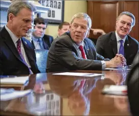  ?? SCOTT APPLEWHITE / AP ?? Sen. Johnny Isakson, flanked by Rep. Buddy Carter, R-Ga., (left) and Sen. David Perdue, R-Ga., leads a meeting with the Georgia Ports Authority and the Army Corps of Engineers on the Savannah Harbor Expansion Project in February.