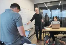  ?? Pam Panchak/Post-Gazette ?? Henry Stafford, CEO and co-founder of Revtown, leads a team meeting at the brand’s Downtown office in 2018. Revtown, which started selling apparel and denim for men, launched a line of women’s jeans on Thursday.