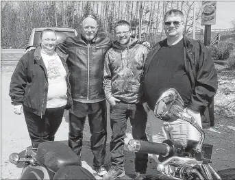  ?? CONTRIBUTE­D PHOTO ?? Michael Tops, right, stands with his son, wife and close friend Eric Payne. While riding motorcycle­s along Brooklyn Street in Centrevill­e in 2005, the bike Payne and Tops’s son were on was struck by a pickup truck. They are pictured here in 2015, when they met to mark the 10th anniversar­y of the event they’ve dubbed “Alive Day.”