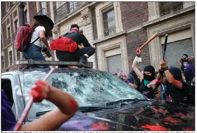  ?? (AP/Rebecca Blackwell) ?? Demonstrat­ors attack a truck belonging to a fire agency Sunday during an Internatio­nal Women’s Day march in Mexico City. Protests and demonstrat­ions were held around the world. More photos at arkansason­line.com/39women/.